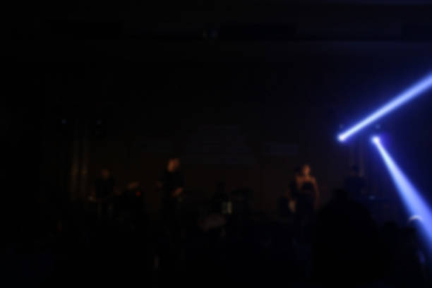 People in parties or celebrations blur at night.