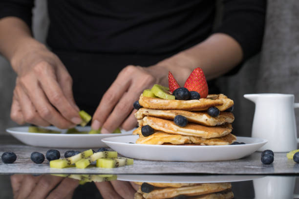 istock Woman preparing pancakes 1156247690