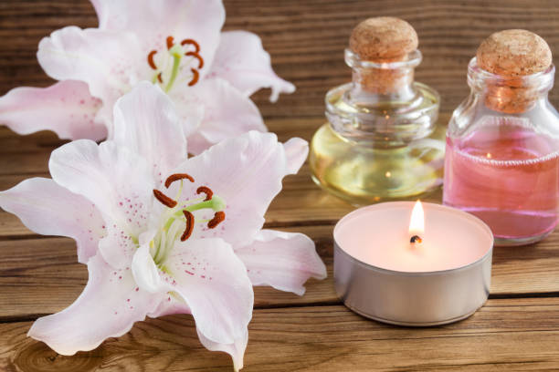 istock Cosmetics oil and candle with lily 1156248736