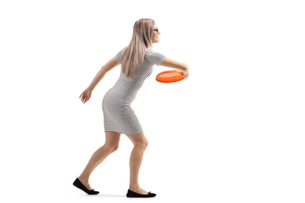istock Woman throwing a frisbee 1156249512