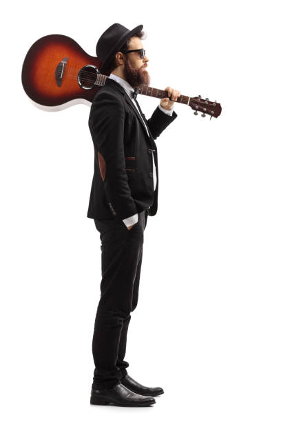 istock Man carrying an acoustic guitar on his shoulder 1156250170