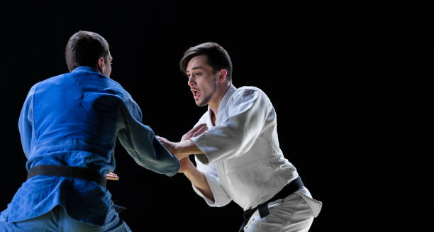 istock Male Judo Players Competing During Match 1156251820