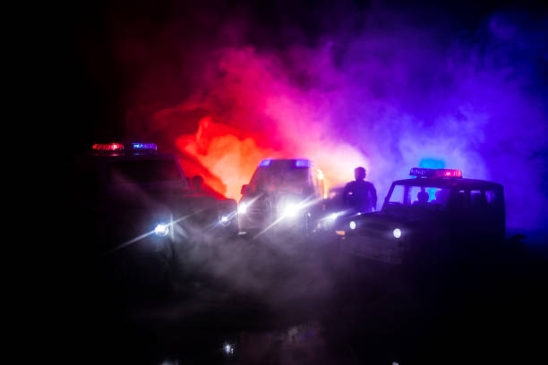 police cars at night. police car chasing a car at night with fog background. 911 emergency response pselective focus - crime scene imagens e fotografias de stock