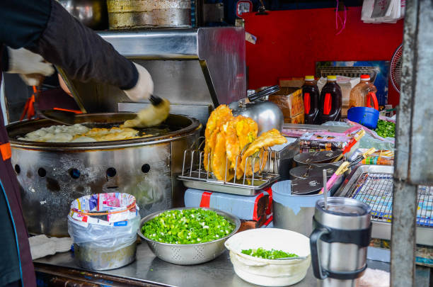 istock Yilan, Taiwan - NOV 04, 2018:Scallion pie vendor sell on the roadside. 1156257341