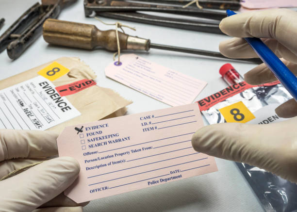 istock Police expert writes about label evidence number, Various laboratory tests forensic equipment, conceptual image 1156257685