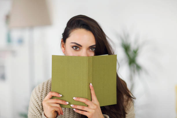 istock Young happy brunette woman with book 1156257753