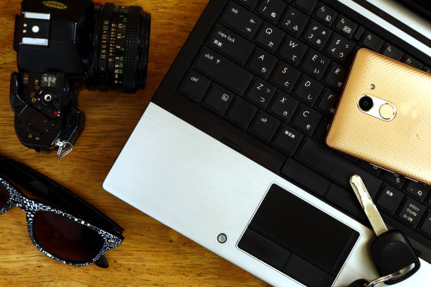 istock Laptop computer, manual camera, car key, sunglasses and smartphone 1156260761