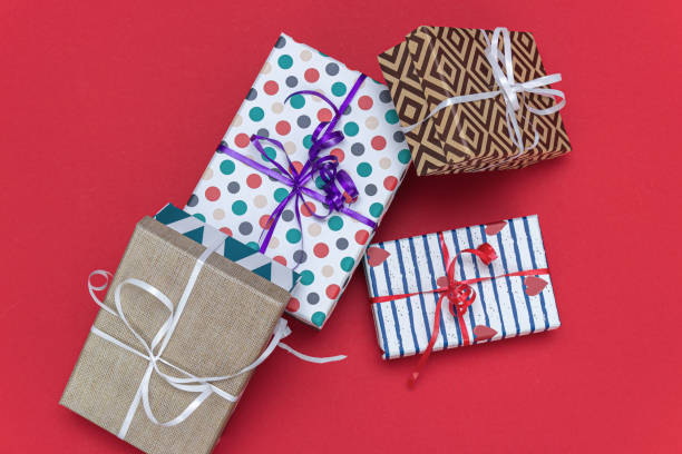 istock Holiday gift boxes, presents isolated on red background. 1156261712