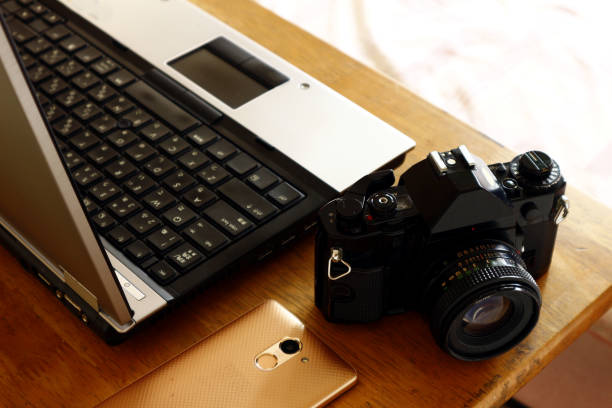 istock Laptop computer, smart phone and manual 35mm film camera 1156261797