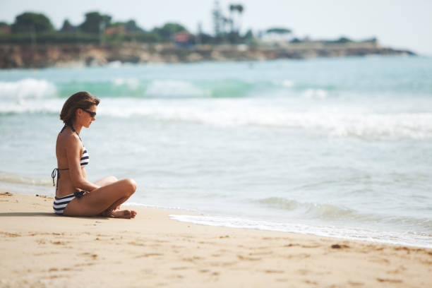 istock Woman at the beach 1156262112
