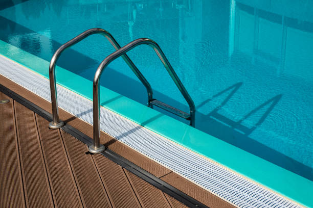 istock Swimming pool with ladder and water for relaxation 1156264727