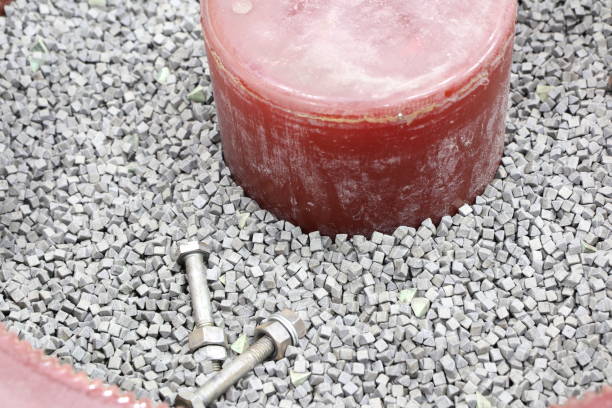 Isolated image of a bolt being in a puddle of motor oil