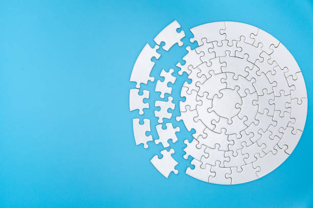 unfinished white jigsaw puzzle pieces on blue background, the last piece of jigsaw puzzle, copy space. - incomplete puzzle jigsaw puzzle part of imagens e fotografias de stock