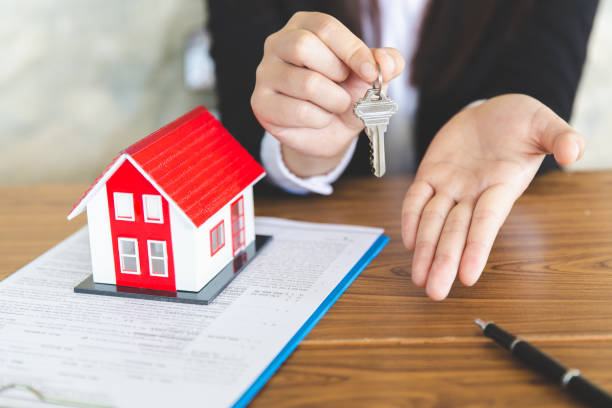 your new house, real estate agent holding house key to his client after signing contract agreement in office,concept for real estate, renting property - key real estate key ring house key imagens e fotografias de stock