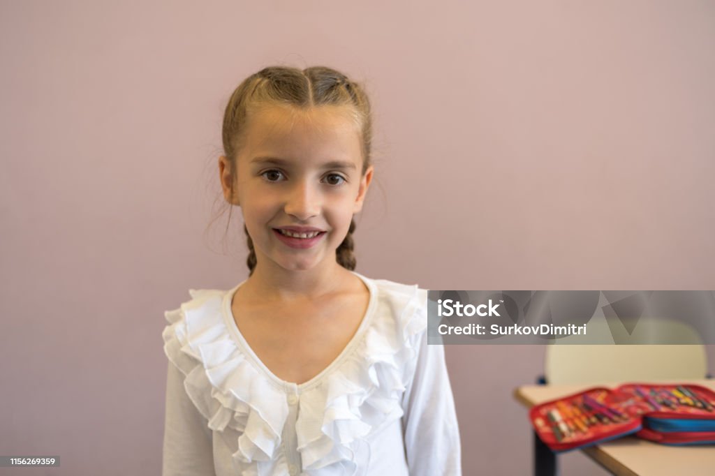 Elementary school student in classroom Pretty elementary school girl posing at camera 6-7 Years Stock Photo