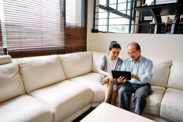 istock Senior Taiwanese couple using digital tablet 1156269486
