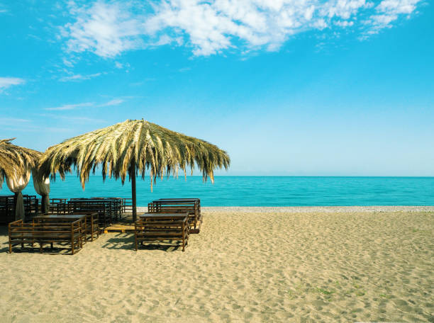istock sandy beach with outdoors cafe at blue sea background 1156269770