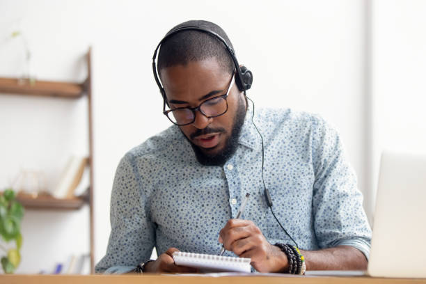 istock African American man in headphones taking E-learning course at office 1156269823