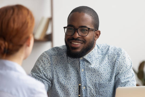 istock Two multiracial business partners speaking, discussing, sharing ideas 1156269824