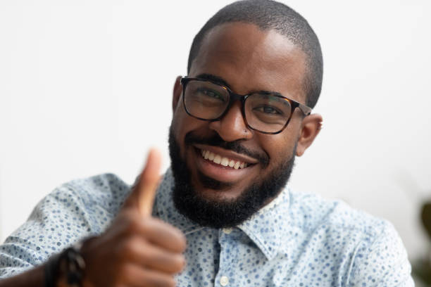 portrait of smart smiling african american businessman gesturing thumbs up - onboard camera imagens e fotografias de stock