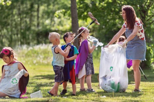 A caring family sorts their waste outdoors, teaching children about recycling.