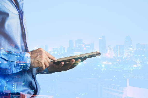 istock double exposure businessman use touch on mobile phone with night cityscape. technology connecting global network online concept. 1156273791