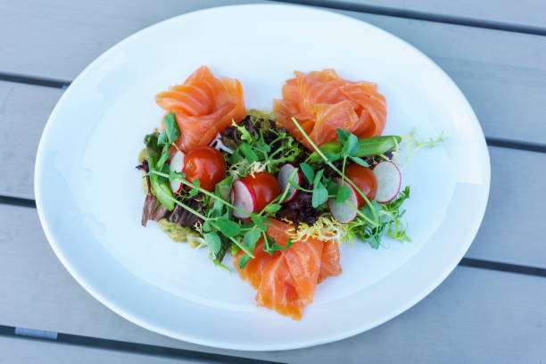 istock Salmon salad with mixed vegetable on white plate 1156275261