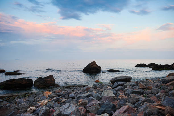 sea landscape at sunset, stone coast and beautiful sky