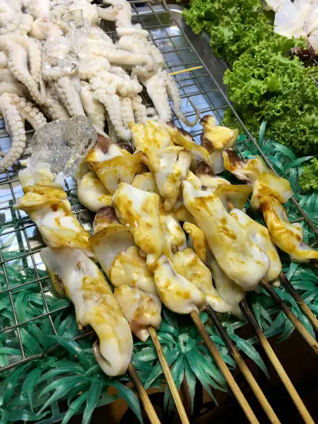 Delicious Grilled squid at street food night market in Bangkok Thailand.