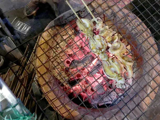 Delicious Grilled squid at street food night market in Bangkok Thailand.