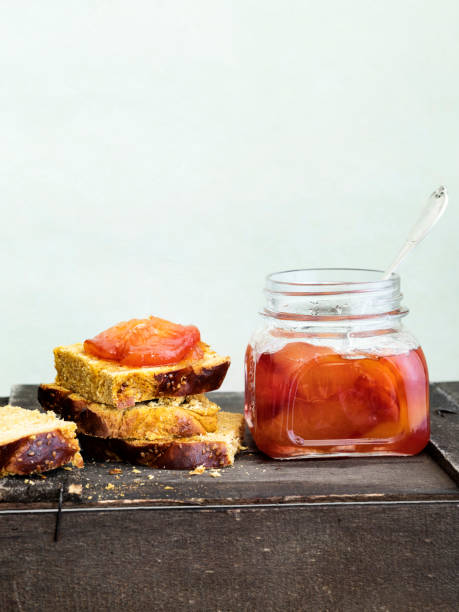 apricot preserves on bread,bread with jam on wood background,bread with jam,peach jam in a jar - preserves jar apricot marmalade imagens e fotografias de stock