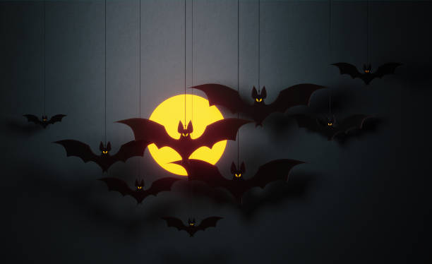 istock Halloween Concept - Cut Out Bats Flaying Over Moon On Black  Background 1156281789