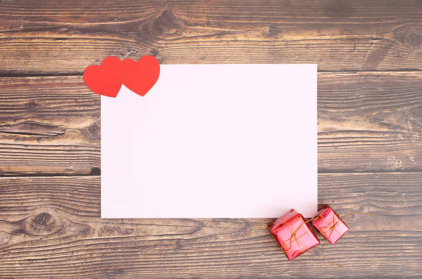 istock Heart with white paper and gift boxes on wooden floors 1156282987