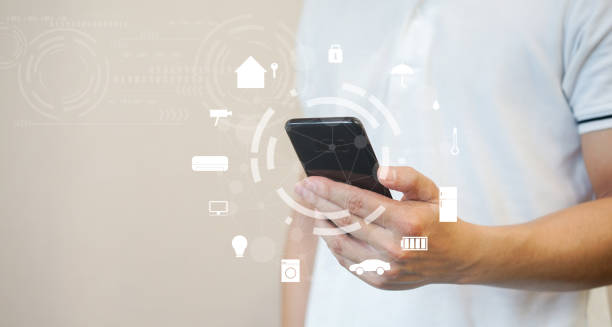 istock close up millennial man holding smartphone and turn on application for using home automation function to looking inside or outside home and property , ai innovation future technology  concept 1156283855