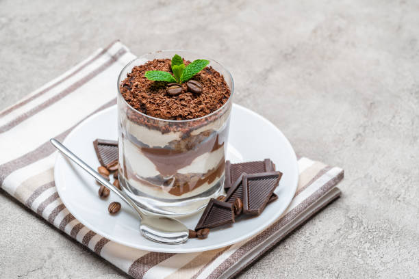 istock Classic tiramisu dessert in a glass on concrete background 1156284002