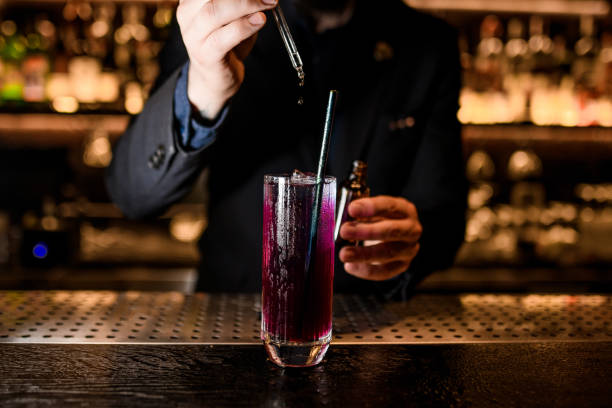 istock Male Bartender makes alcohol cocktail with dropper 1156285809