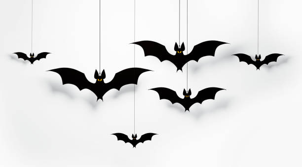 Halloween Decorations - Cut Out Bats Flaying On White Background Cut out black bats flying on white background Horizontal composition with copy space. Halloween concept. isolated bat stock pictures, royalty-free photos & images