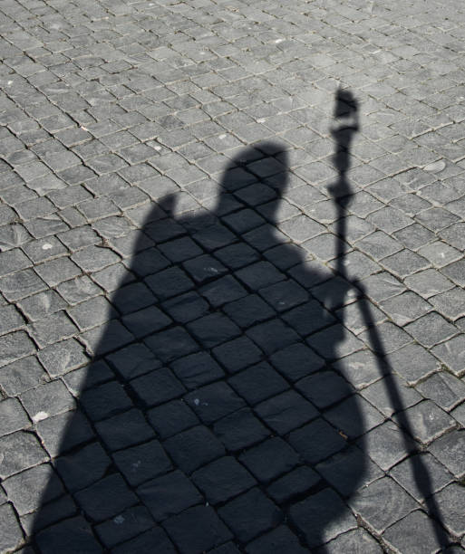 istock Shadow man, abstract black-and-white image of shadow on cobblestones, abstract 1156287769
