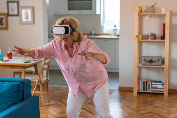 istock Senior woman having fun with virtual reality headset 1156293981
