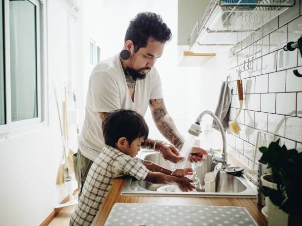 istock Asian Baby Boy Helping Father with the House Work 1156296831