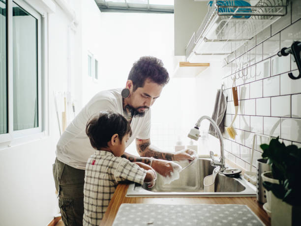 istock Asian Baby Boy Helping Father with the House Work 1156297370