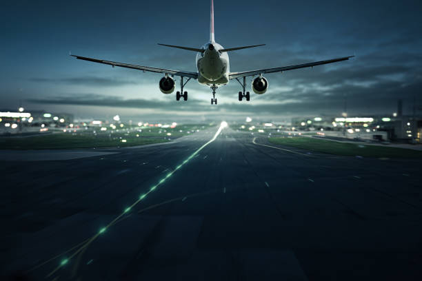 Airplane landing at night stock photo