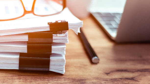 istock Stack of documents placed on a business desk in a business office. 1156300411