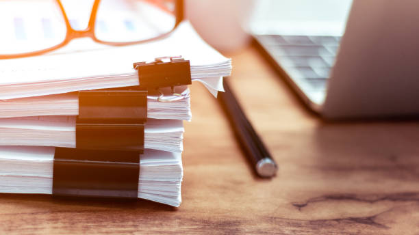 Stack of documents placed on a business desk in a business office. stock photo