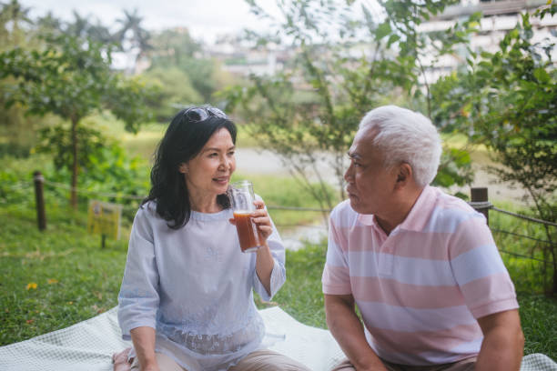 istock Three Asia Senior Retirement Having Picnic In Park Concept 1156300561
