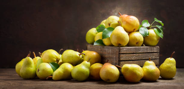 istock fresh pears with leaves in a wooden box 1156301393