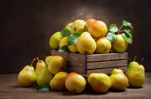 istock fresh pears with leaves in a wooden box 1156301394