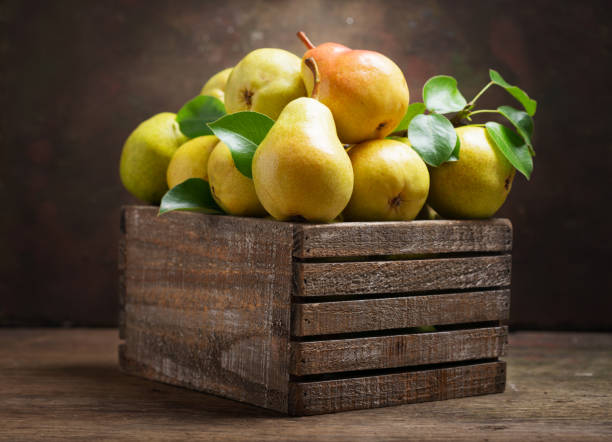 istock fresh pears with leaves in a wooden box 1156301396