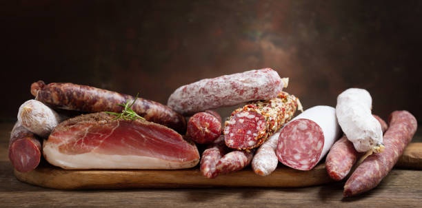 Various kind types of salami, speck and sausages stock photo