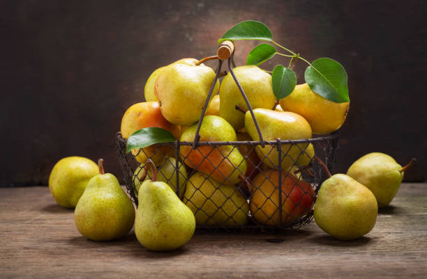 istock fresh ripe pears with leaves in a basket 1156301410